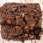 Stack of thick slices of Chocolate Zucchini Bread showing the moist, tender crumb and melted chocolate chips throughout each slice.