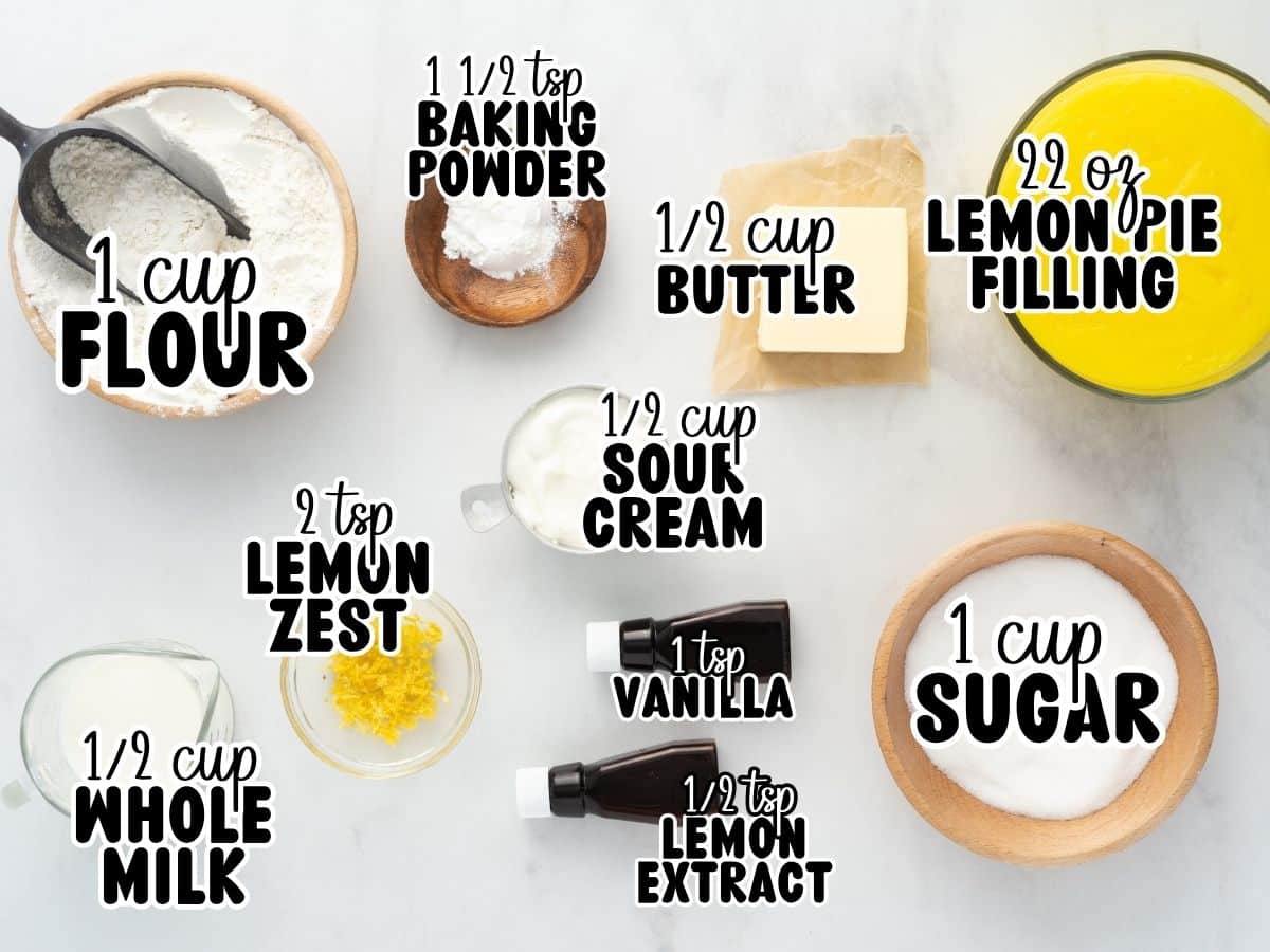Ingredient collage for Lemon Cobbler with labeled measurements including flour, sugar, baking powder, sour cream, whole milk, lemon zest, vanilla extract, lemon extract, butter, and lemon pie filling. Text reads: “1 cup flour,” “1 cup sugar,” “1 ½ tsp baking powder,” “½ cup sour cream,” “½ cup whole milk,” “2 tsp lemon zest,” “1 tsp vanilla,” “½ tsp lemon extract,” “½ cup butter,” and “22 oz lemon pie filling.”