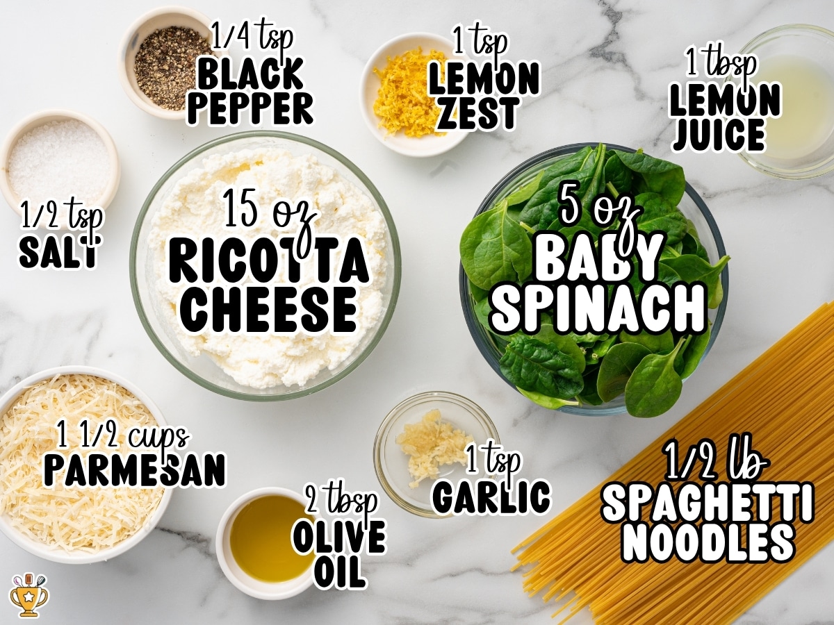Top-down ingredient photo for Lemon Ricotta Pasta featuring labeled ingredients on a marble background, including 15 oz ricotta cheese, 1&frac12; cups parmesan, 5 oz baby spinach, &frac12; lb spaghetti noodles, 2 tbsp olive oil, 1 tbsp lemon juice, 1 tsp lemon zest, 1 tsp garlic, &frac12; tsp salt, and &frac14; tsp black pepper.