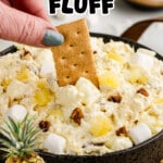 Pinterest graphic showing a bowl of creamy Pineapple Fluff with a graham cracker dipped into the dessert and the text "The Creamiest Pineapple Fluff" and "Made with just 6 ingredients!"
