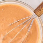 Pinterest graphic for 3-Ingredient Red Robin Campfire Sauce showing a glass bowl of creamy sauce with a whisk and text reading "3-Ingredient Red Robin Campfire Sauce," "⅔ cup mayonnaise," "½ cup hickory bourbon flavored BBQ sauce," and "⅛ teaspoon chili powder."