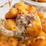 Pinterest pin for Easiest Hamburger Tater Tot Casserole, featuring a forkful of the casserole with melted cheese, ground beef, green beans, and tater tots, with text overlay "in the oven in 15 minutes!" and a box of Ore-Ida tater tots.