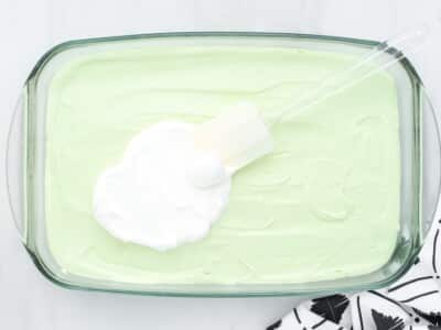 Whipped topping being spread over the key lime layer
