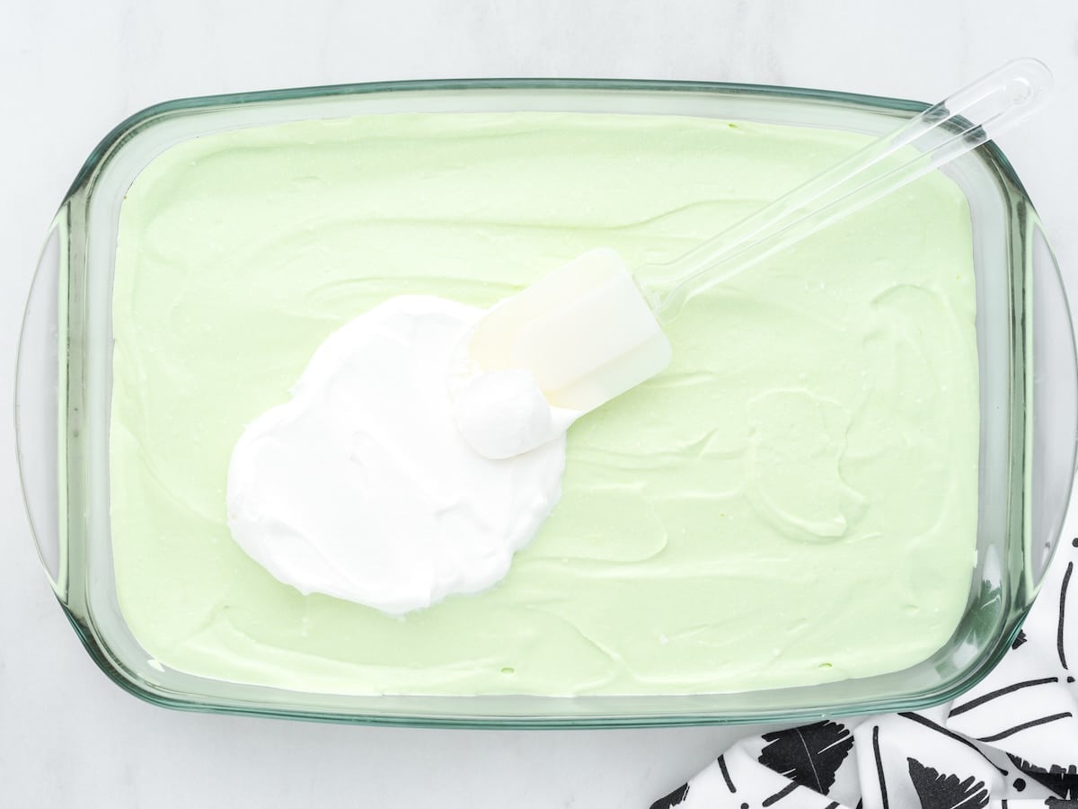 Whipped topping being spread over the key lime layer