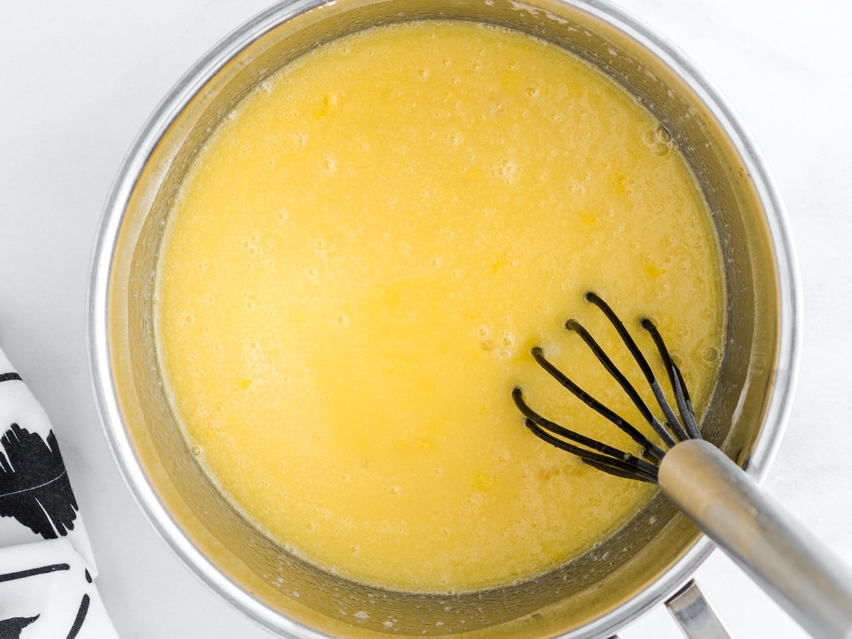 Key lime custard mixture whisked together in a saucepan before cooking