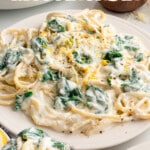 One pot lemon ricotta pasta with spinach on a plate, topped with parmesan, lemon zest, and black pepper, ready in 15 minutesOne pot lemon ricotta pasta with spinach on a plate, topped with parmesan, lemon zest, and black pepper, ready in 15 minutes