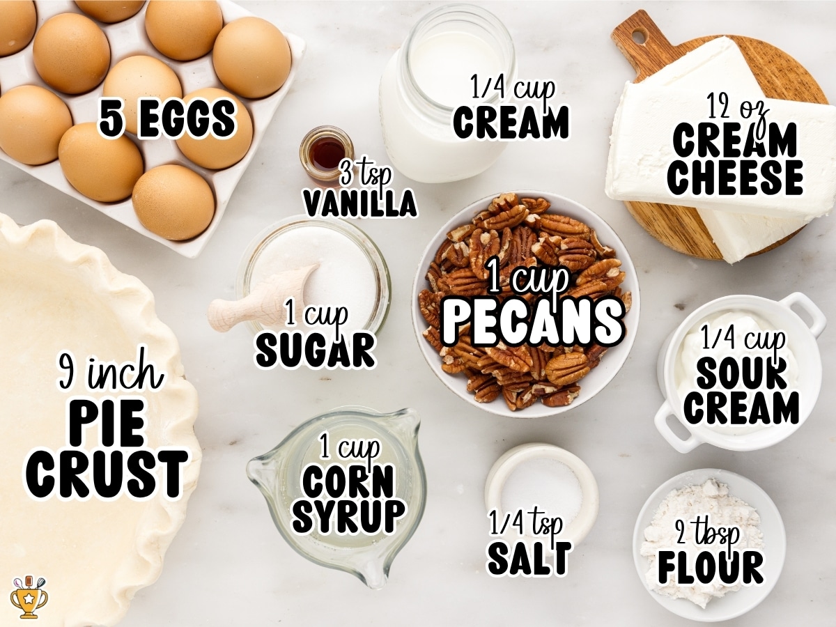 Overhead display of Pecan Cheesecake Pie ingredients labeled 5 eggs, 3 tsp vanilla, ¼ cup cream, 12 oz cream cheese, 1 cup pecans, 1 cup sugar, ¼ cup sour cream, 9-inch pie crust, 1 cup corn syrup, ¼ tsp salt, and 2 Tbsp flour.