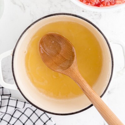 Fruit pectin dissolved in water and heated in a saucepan before being added to the strawberries to make homemade Strawberry Freezer Jam.
