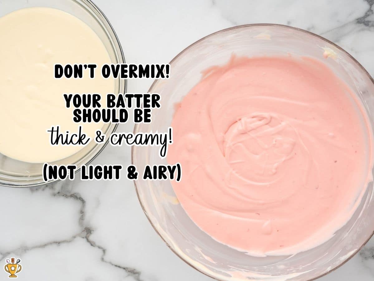 Bowls of thick, creamy vanilla and pink strawberry cheesecake batter side by side, showing the smooth consistency to aim for without overmixing.