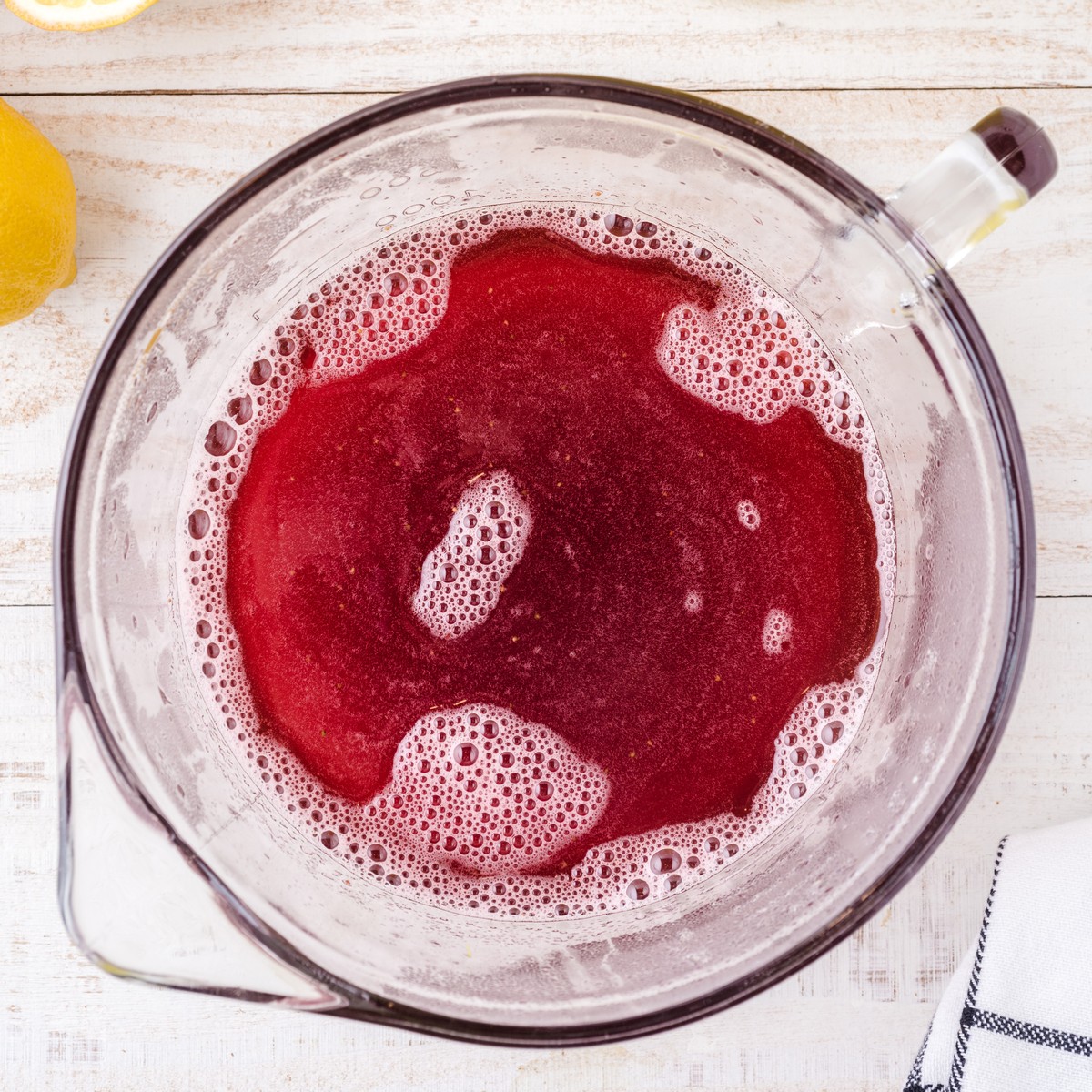 Homemade strawberry syrup blended until smooth for Strawberry Lemonade before being added to the prepared lemonade.