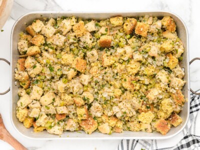 Prepared Cornbread Stuffing mixture spread evenly in a large baking pan before baking.