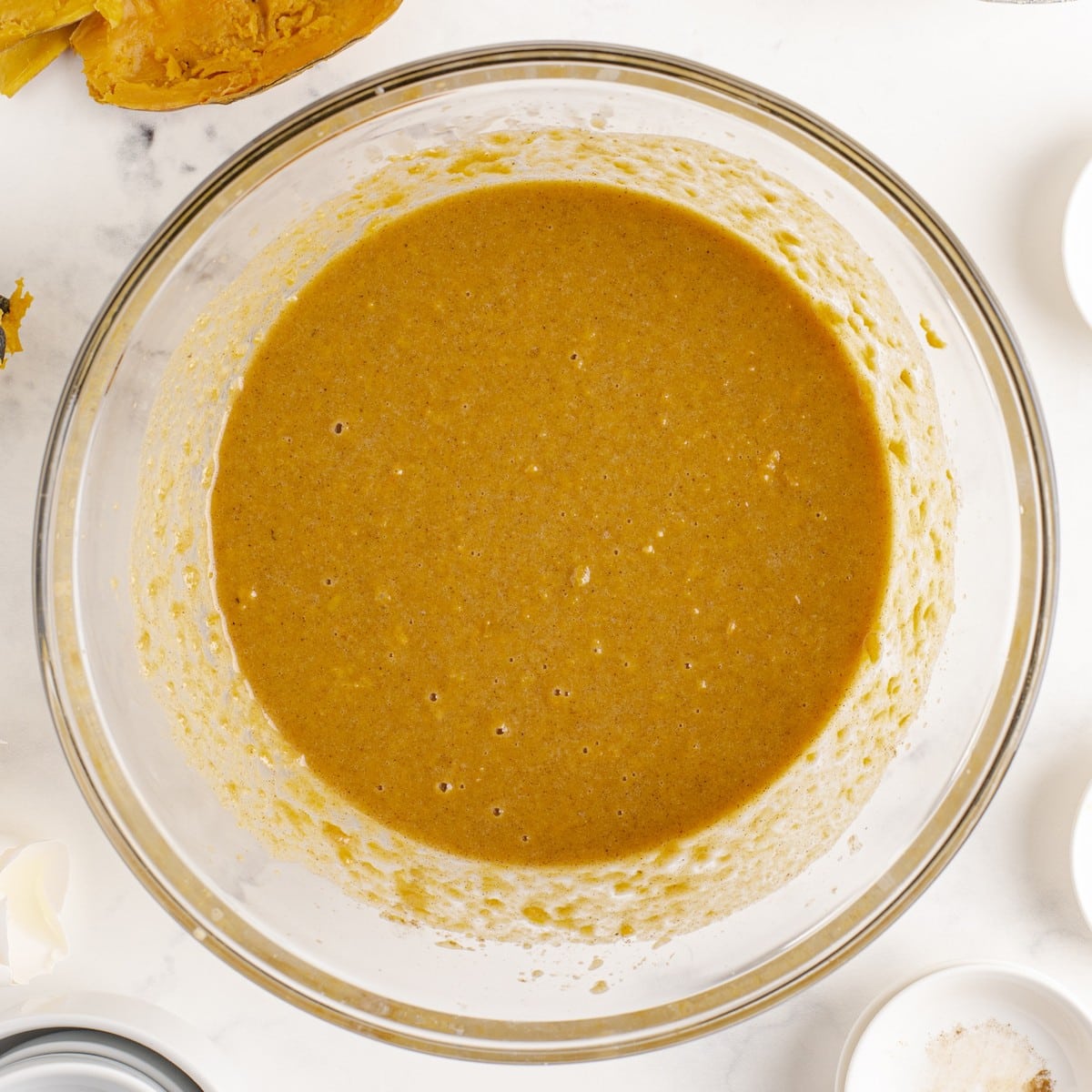 Smooth, blended Sweet Potato Pie filling in a glass mixing bowl, ready to be poured into the prepared pie crust.